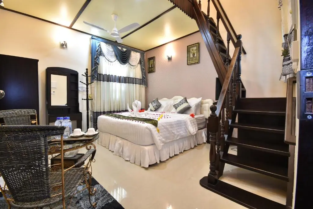 Family room interior with staircase at Holiday Haven, Ukulhas Island, Maldives
