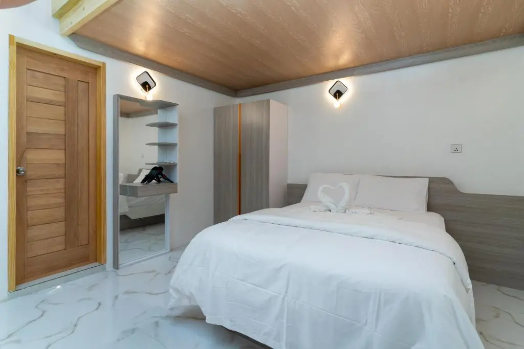 Guest room with double bed and wardrobe at La Liviera, Ukulhas Island, Maldives