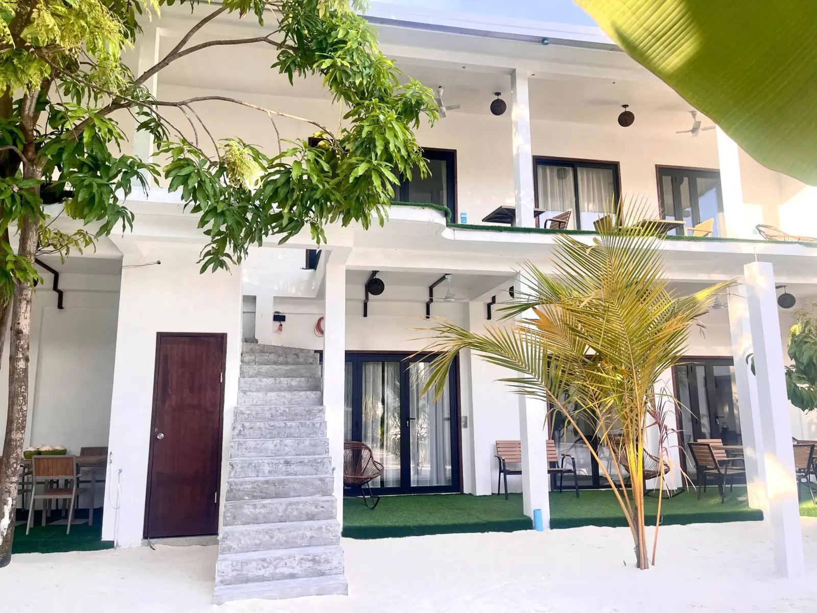 White two-storey suites building with garden at La Palma Suites, Ukulhas Island, Maldives