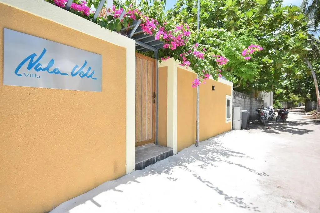 Entrance gate with property sign and bougainvillea at Nala Veli Villa, Ukulhas Island, Maldives