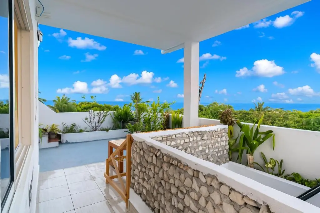 Rooftop terrace with sea view over the treetops at Olhumathi View Inn, Ukulhas Island, Maldives