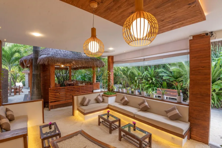 Palm-shaded outdoor area at Ostrov Hotel on Ukulhas Island, Maldives