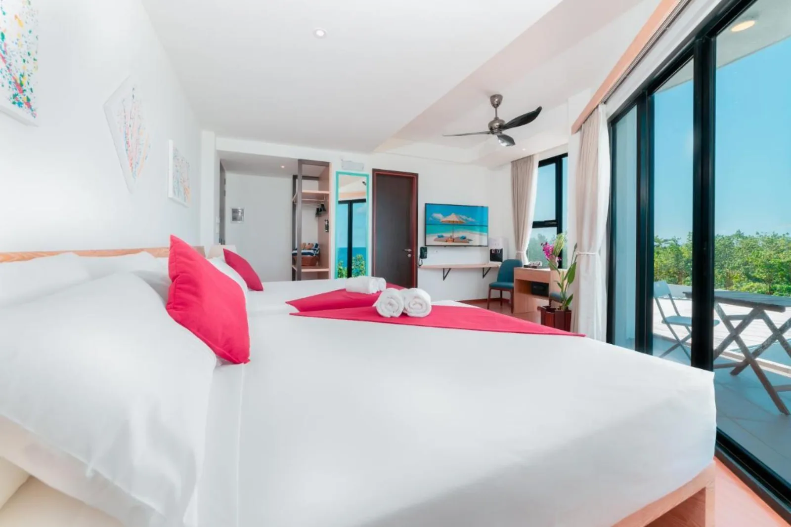 Bright sea-view room with a king bed, balcony and sliding doors at Ranthari Hotel & Spa, Ukulhas Island, Maldives