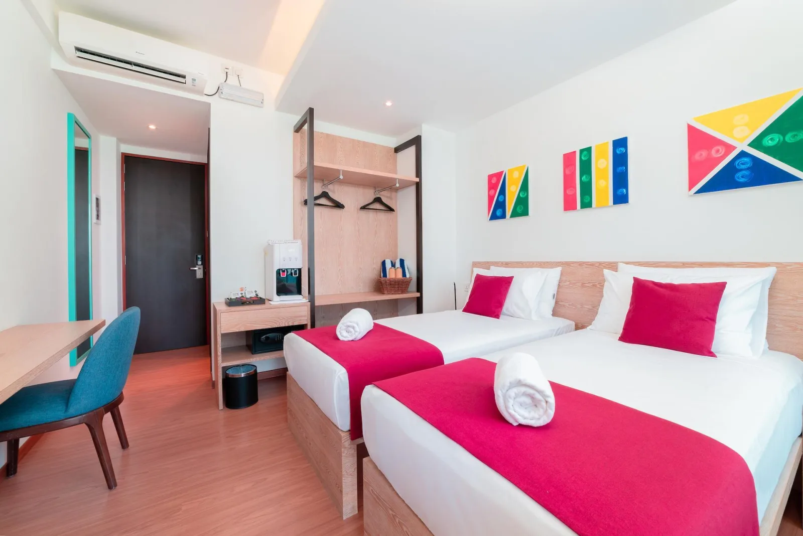 Twin guest room with two beds, wardrobe and desk at Ranthari Hotel & Spa, Ukulhas Island, Maldives