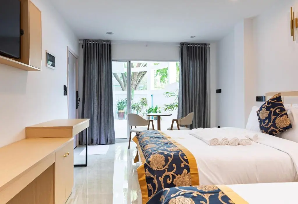 Guest room with double bed and work desk at Sandy Blooms, Ukulhas Island, Maldives