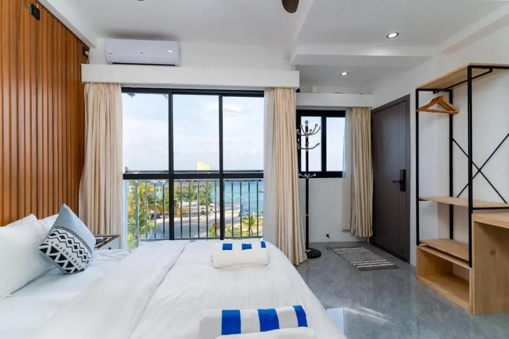 Guest room with balcony and a glimpse of the sea at Seaside Oceanview, Ukulhas Island, Maldives