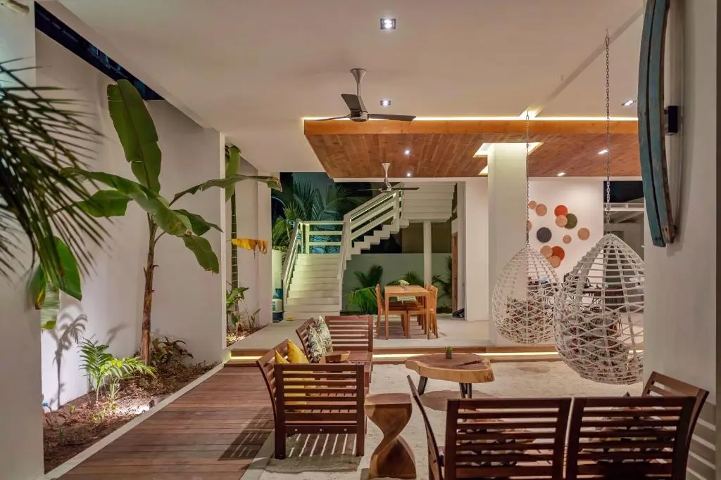 Open-plan lounge terrace with stone feature wall at Shaviyani Retreat, Ukulhas Island, Maldives