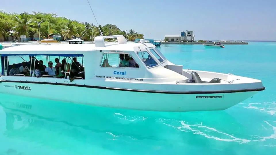 Speedboat named Coral docked at a jetty, with RASHODHOO UKULHAS FOLHUDHOO MATHIVERI FERRY lettering on the hull
